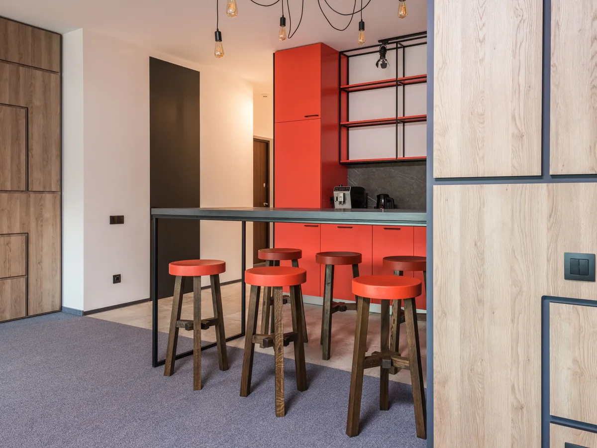 Below-grade bar cabinetry built on a moisture-isolated base in a finished basement
