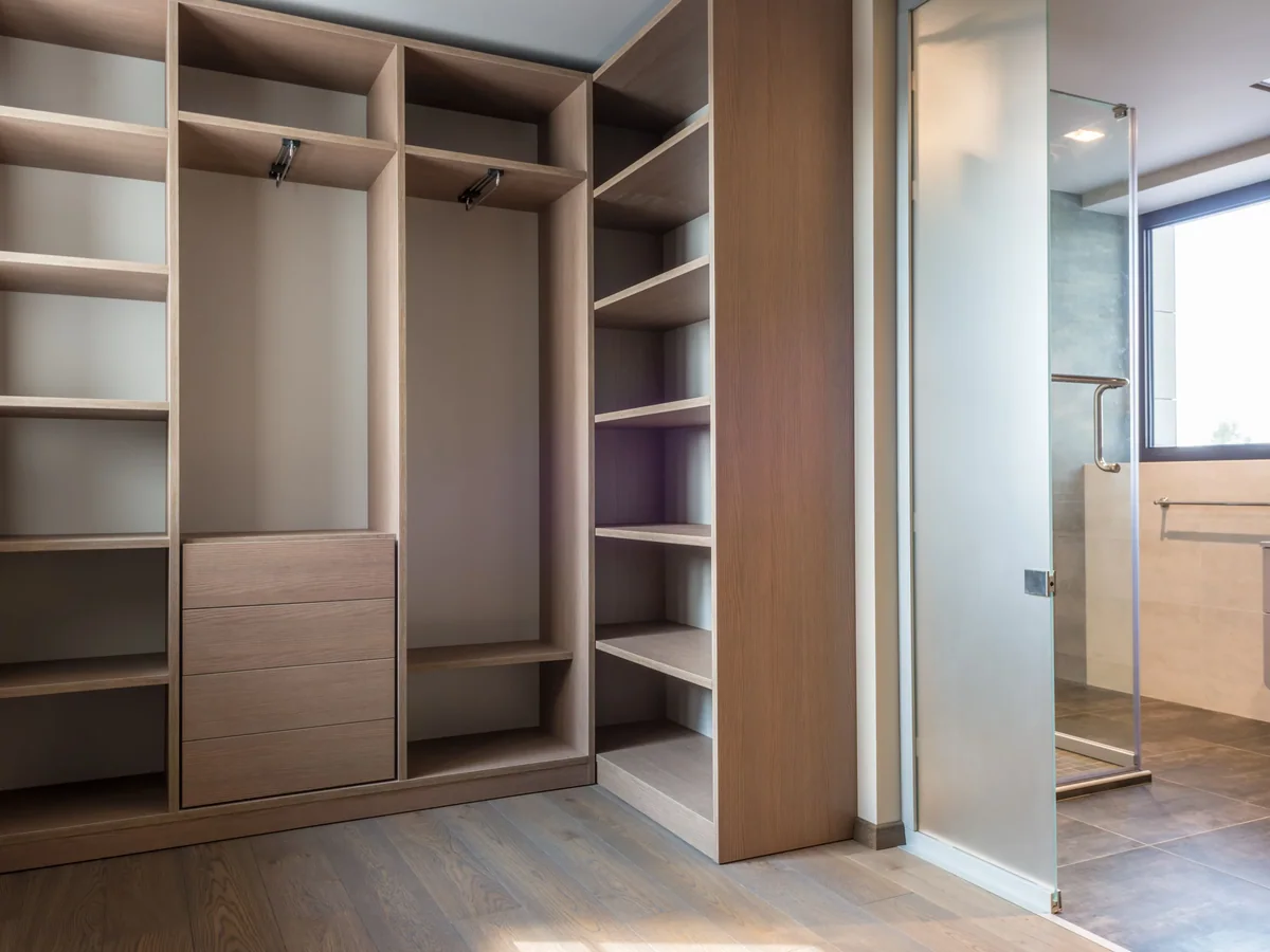 Felt-lined drawer bank and adjustable shoe shelving inside a custom closet system