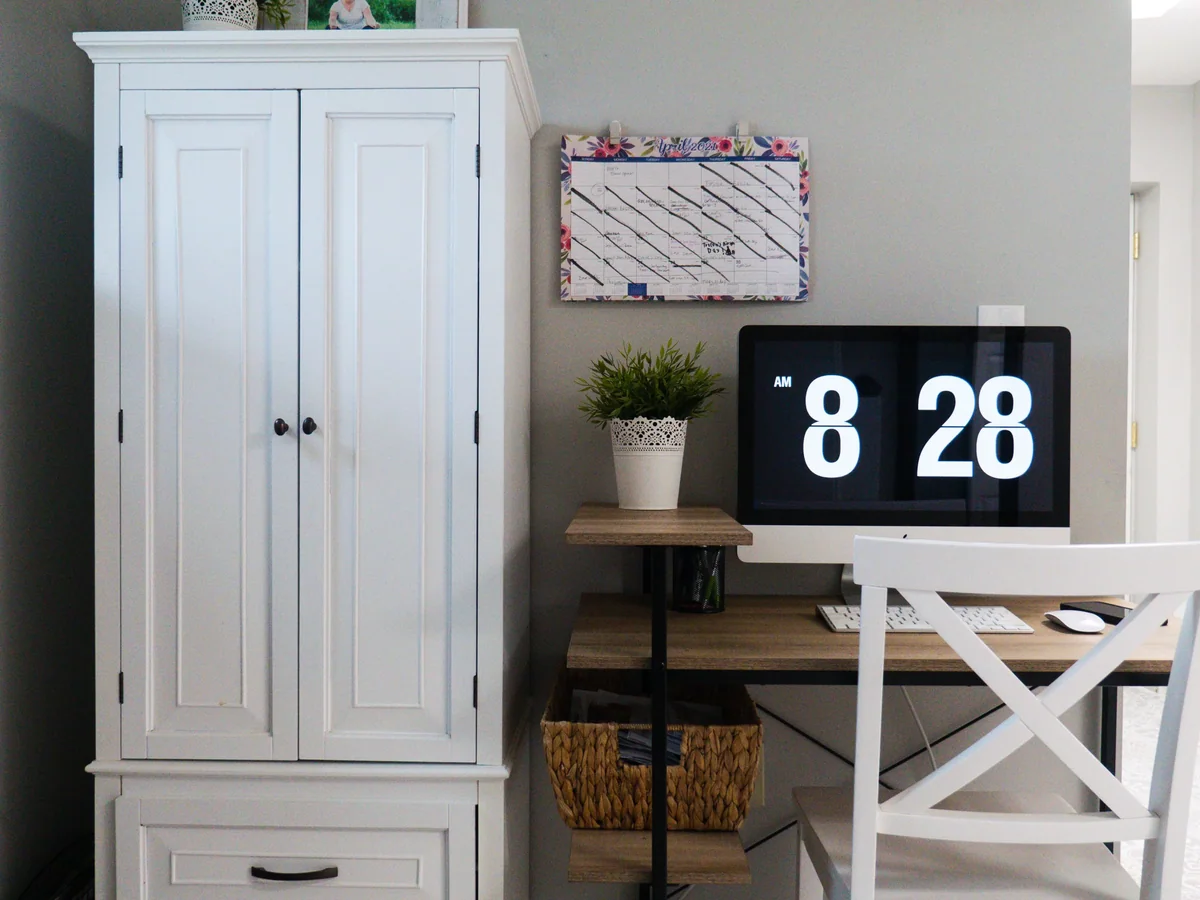 Shallow supply drawers and vertical paper storage built into a custom craft room cabinet