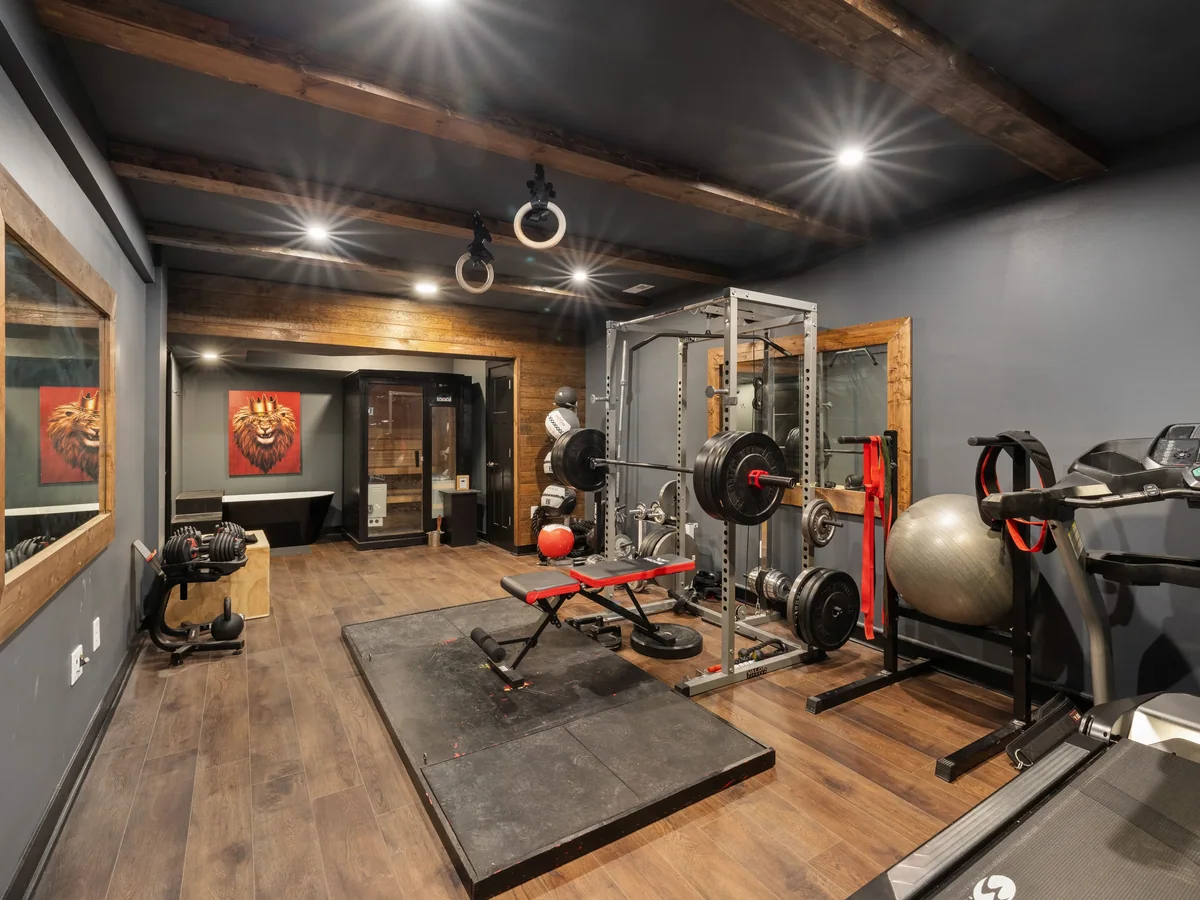 Ventilated locker bays and a load-rated weight shelf in a custom home gym cabinet run