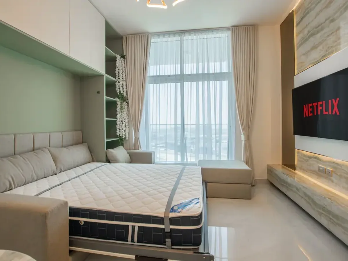Dual-purpose guest room where a wall bed system frees usable daytime floor space
