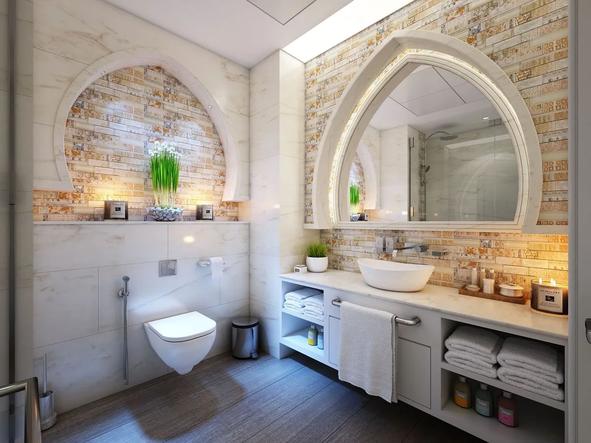 Rolled linen storage and a warming cabinet niche built into a spa treatment room