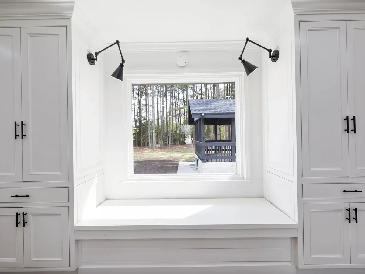 Soft-close lift-top lid and interior storage bay inside a built-in window bench